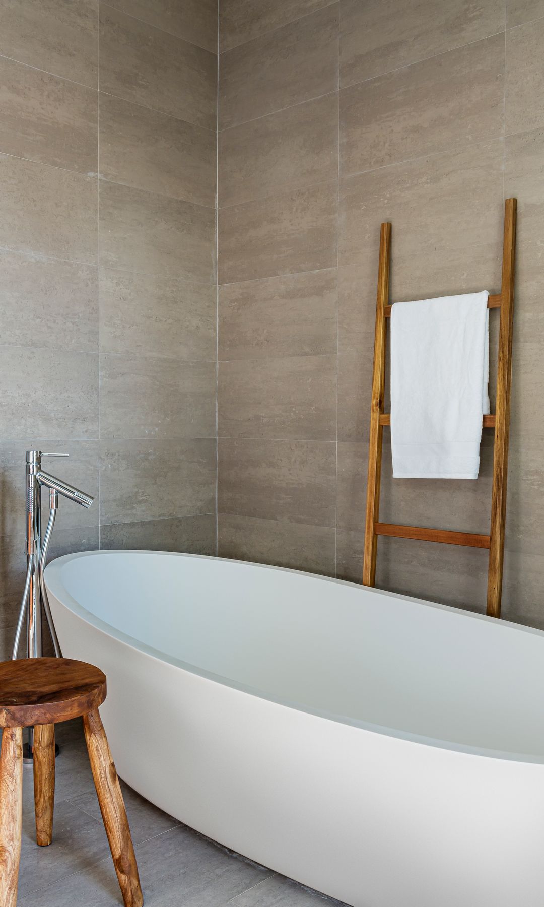 Bañera exenta blanca con taburete y escalera toallero de madera