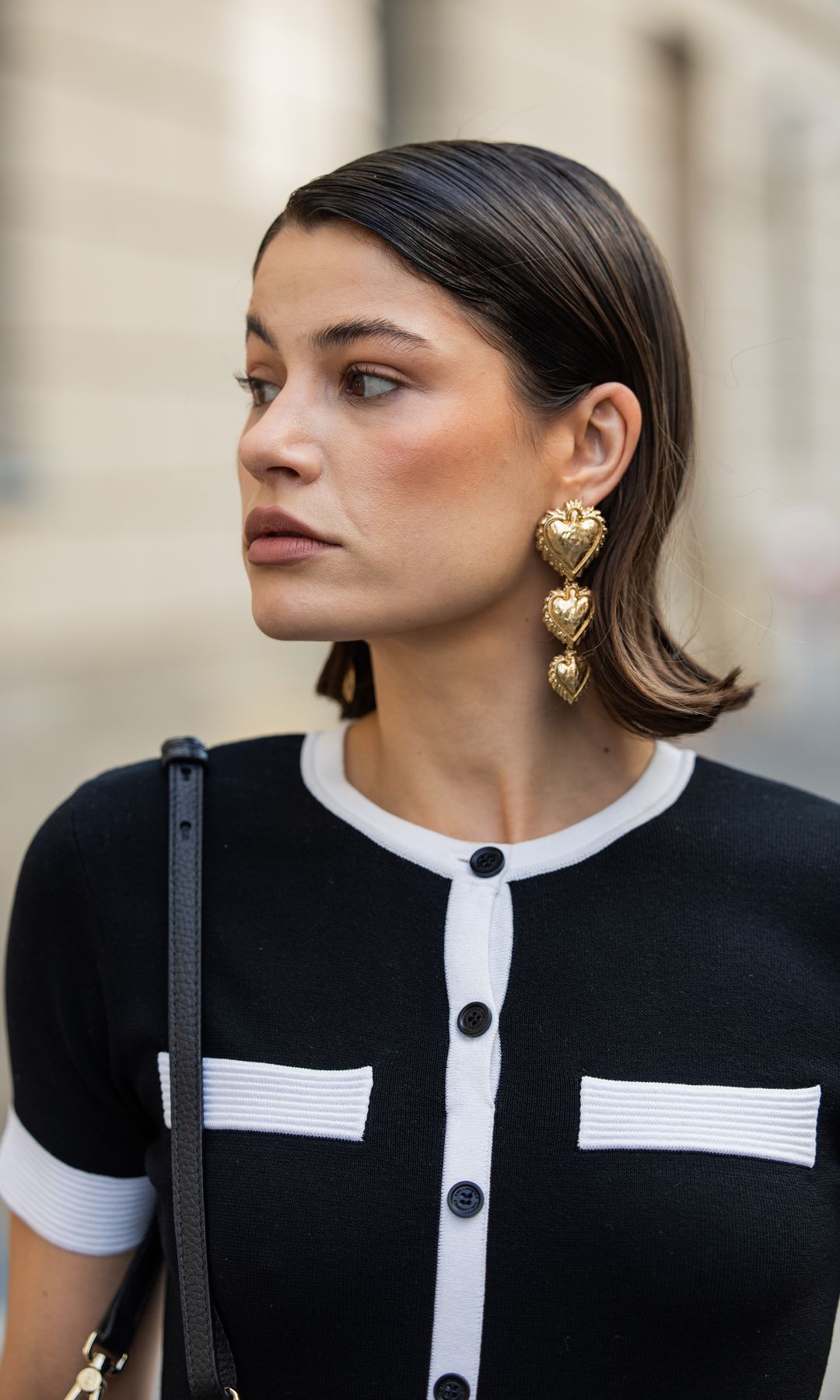 BERLIN, GERMANY - MAY 05: Lea Naumann wears earrings Mango, black white striped button up dress Karl Lagerfeld, bag Aigner Munich on May 05, 2024 in Berlin, Germany