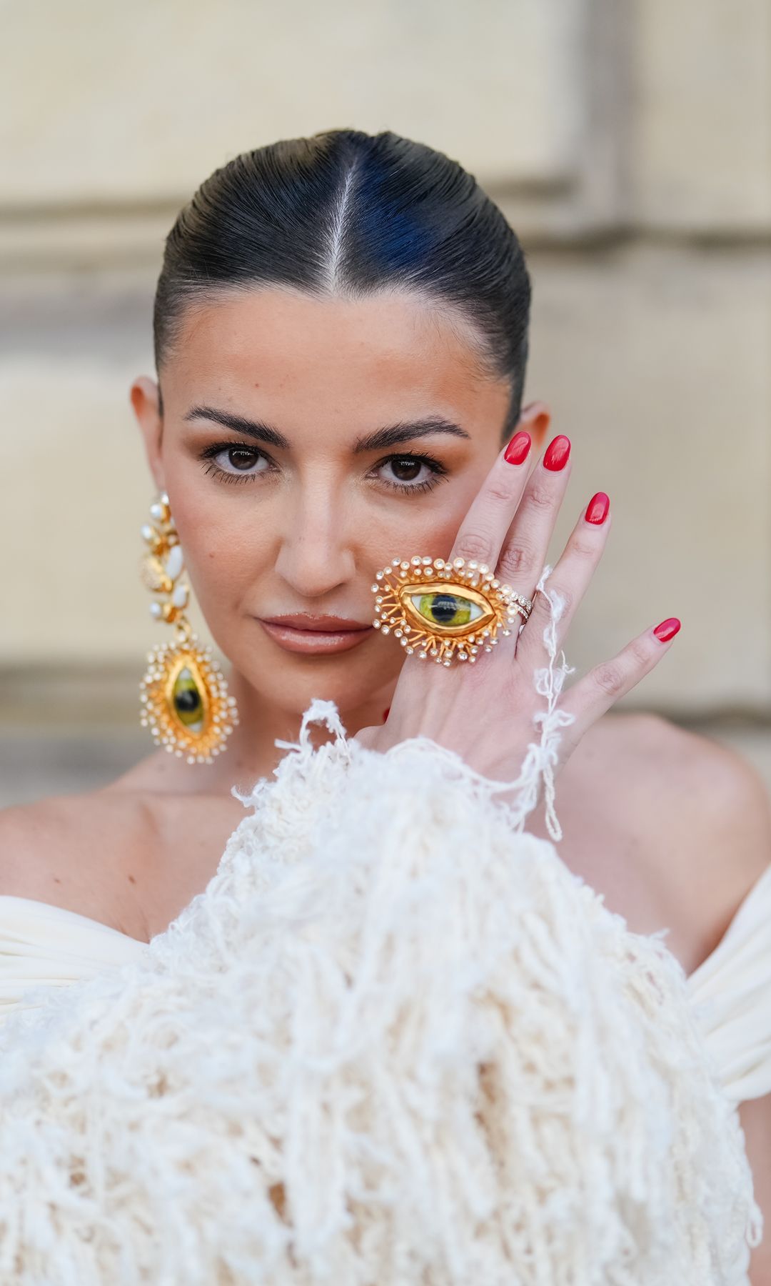 PARIS, FRANCE - JUNE 24: Alexandra Pereira wears gold Schiaparelli jewelry, outside Schiaparelli, during the Paris Haute Couture Week Fall/Winter 2024-2025 on June 24, 2024 in Paris, France