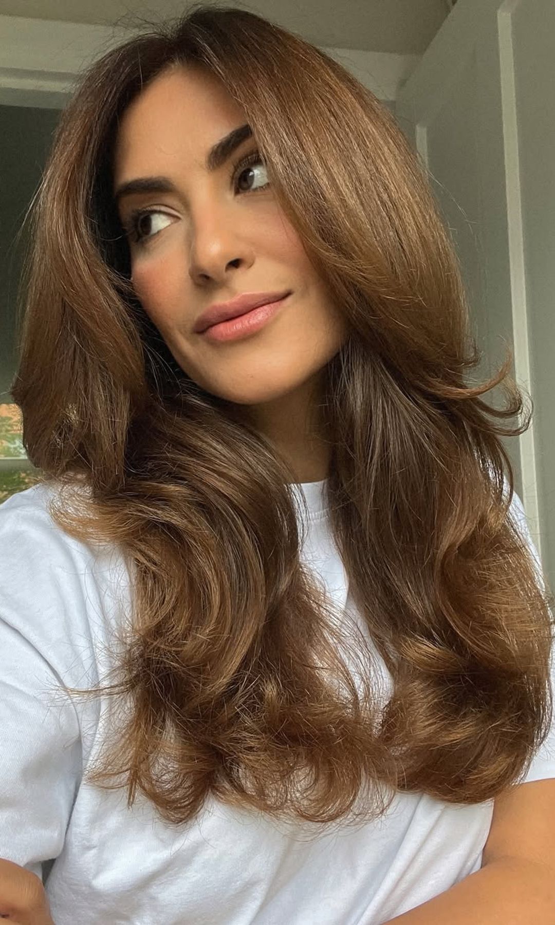 Sarah Angius con melena larga castaña con volumen y ondas suaves