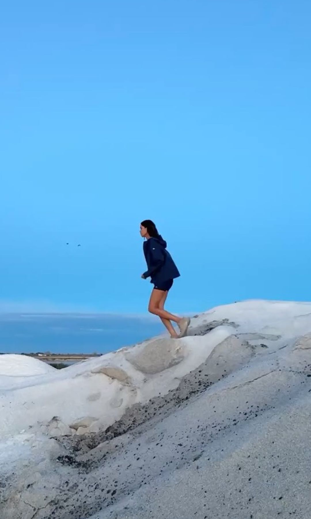 Mujer haciendo ejercicio en la playa al amanecer
