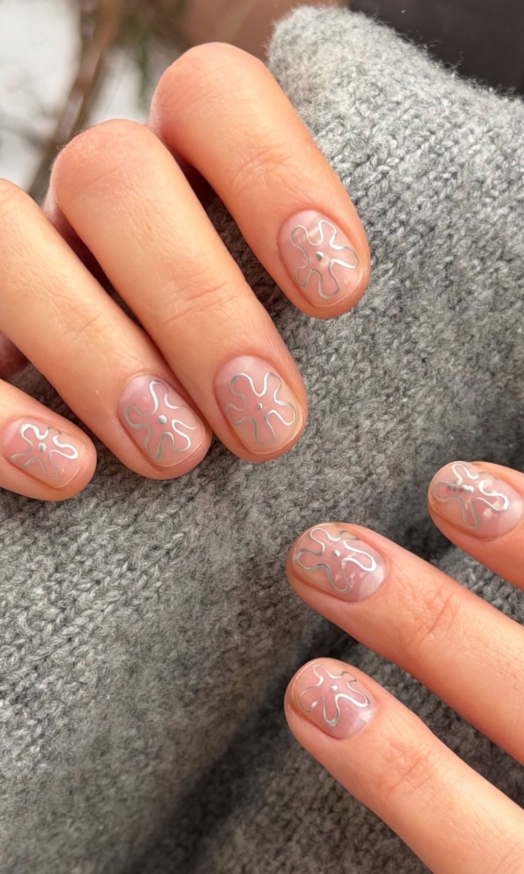 Manicura plateada con flores