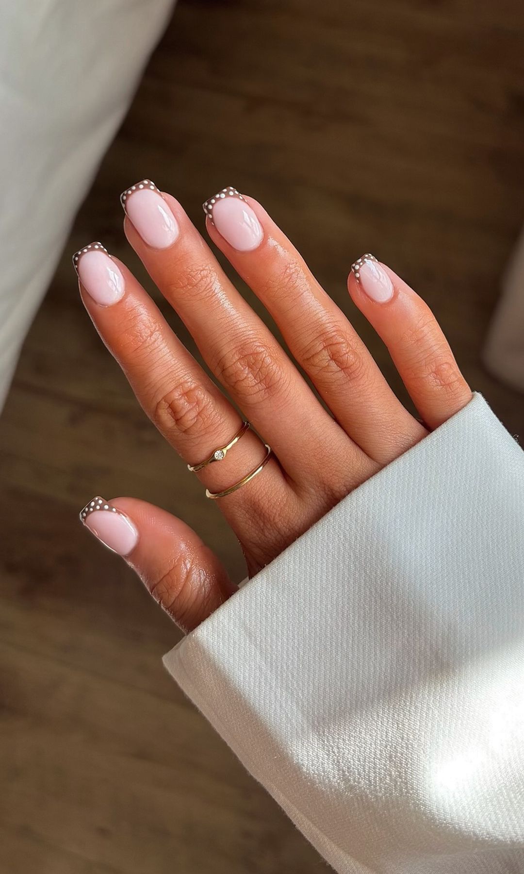 Manos con manicura francesa con lunares