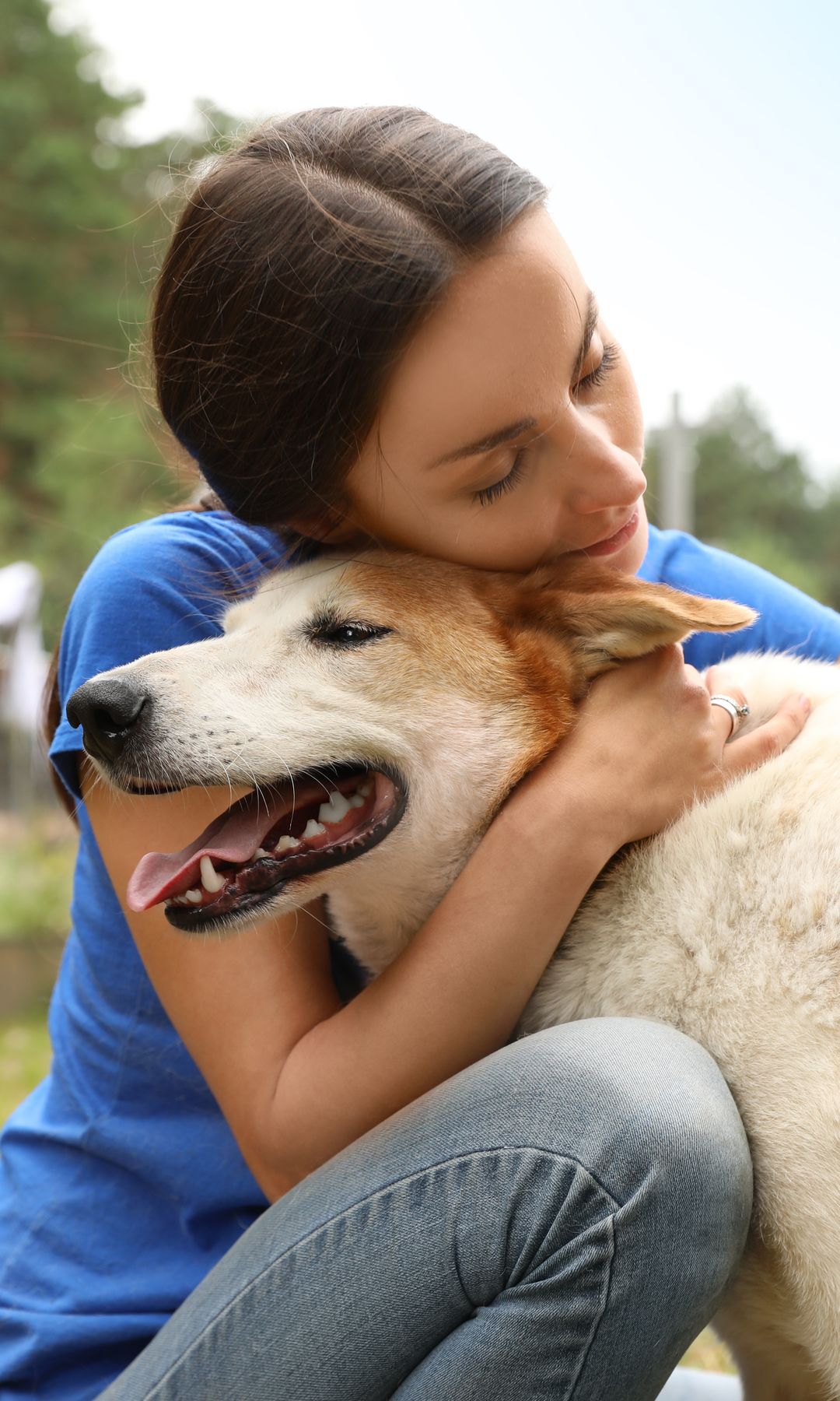 mujer abraza a un perro en la calle