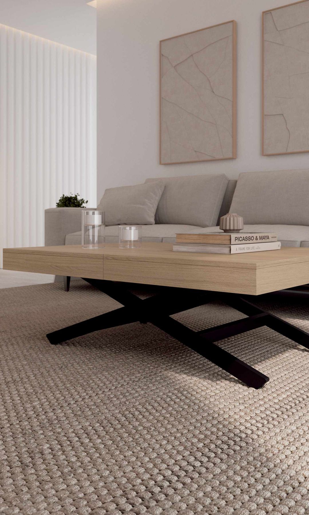 Salón con sofá beige, alfombra de fibras vegetales,  mesa de centro elevable con el sobre de madera y las patas negras, cuadros en la pared