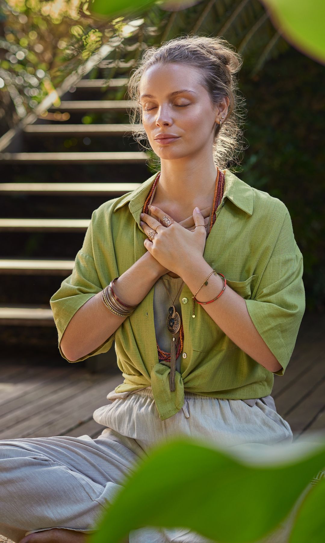 Una mujer haciendo respiraciones en el jardín y meditando