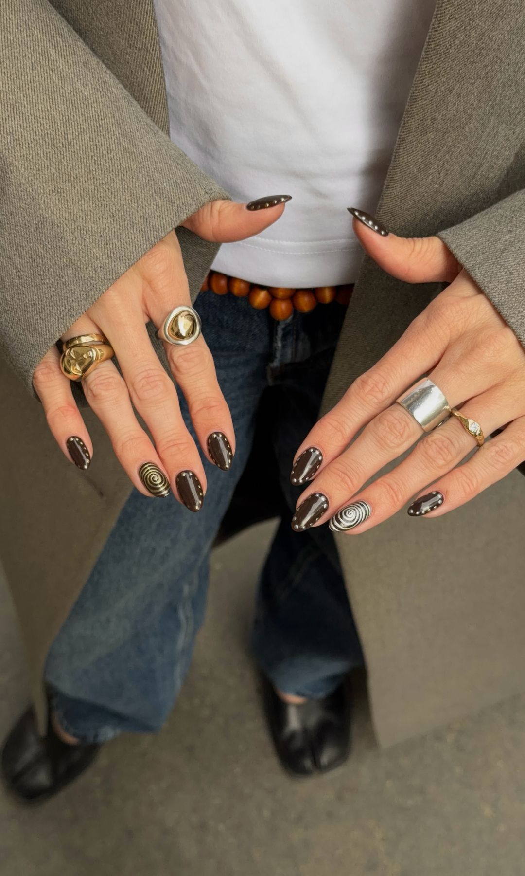 Manicura marrón chocolate con detalles en plateado y dorado