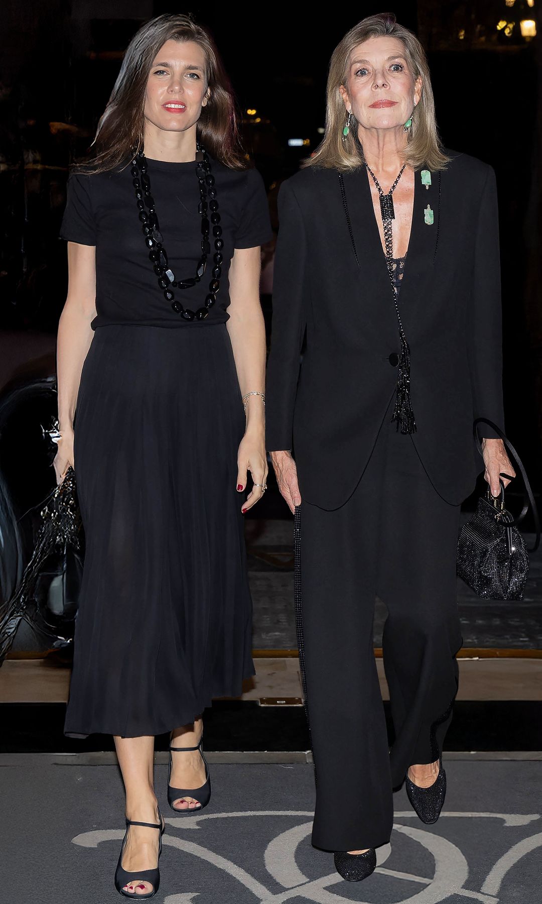 Sintonía de estilo y mucho cariño, en la Ópera de Montecarlo. La princesa, de 68 años, y Carlota, de 39, vistieron a juego en negro. Carolina llevó un traje sastre con un collar largo (al igual que su hija) y pendientes y dos broches en piedra verde jade. Y Carlota, falda larga plisada y camiseta