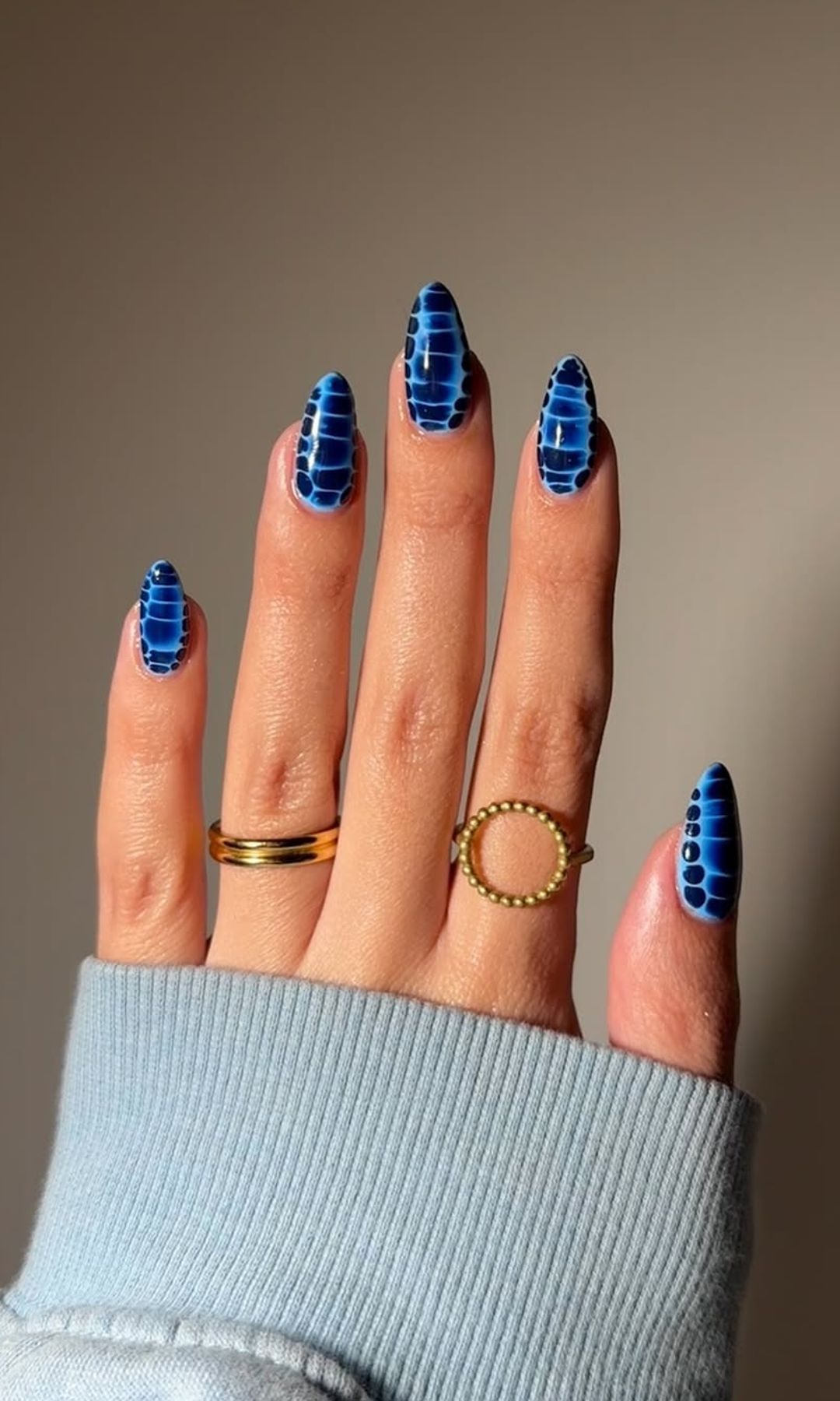 Uñas mariposa azules con diseño inspirado en alas y acabado brillante sobre forma almendrada