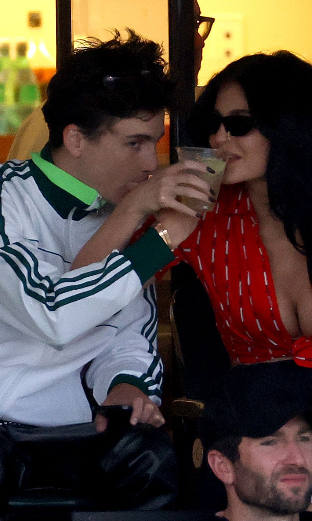 Kylie Jenner Timothee Chalamet sitting drinking