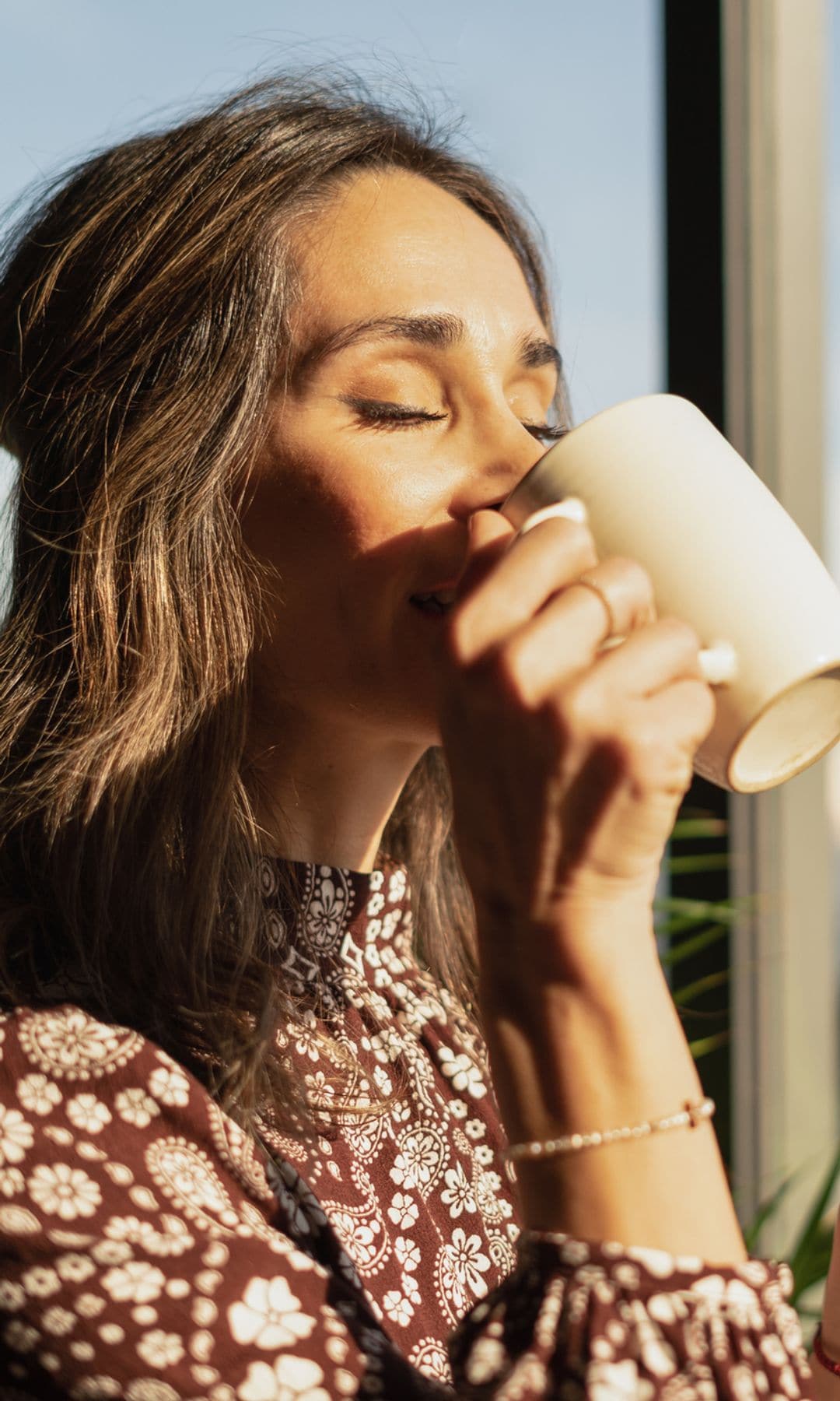 Una mujer tomando café en su casa