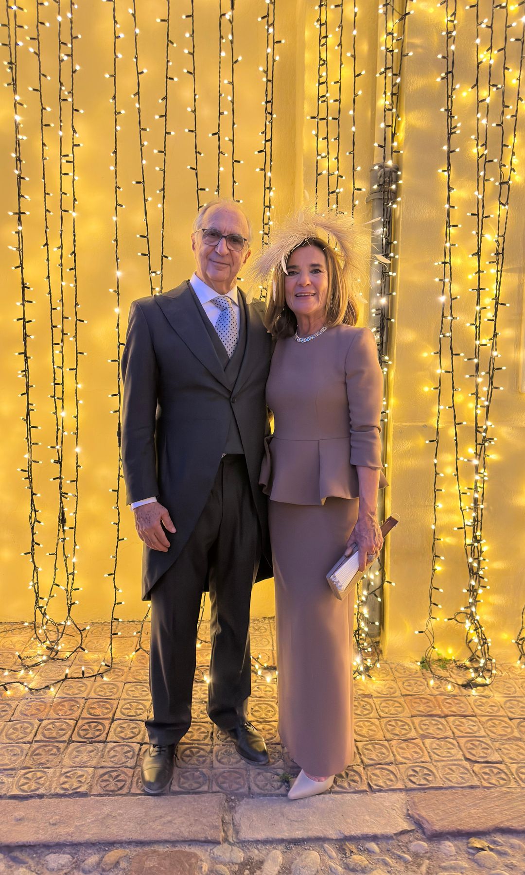 madrina de boda con estilo y tocado de plumas