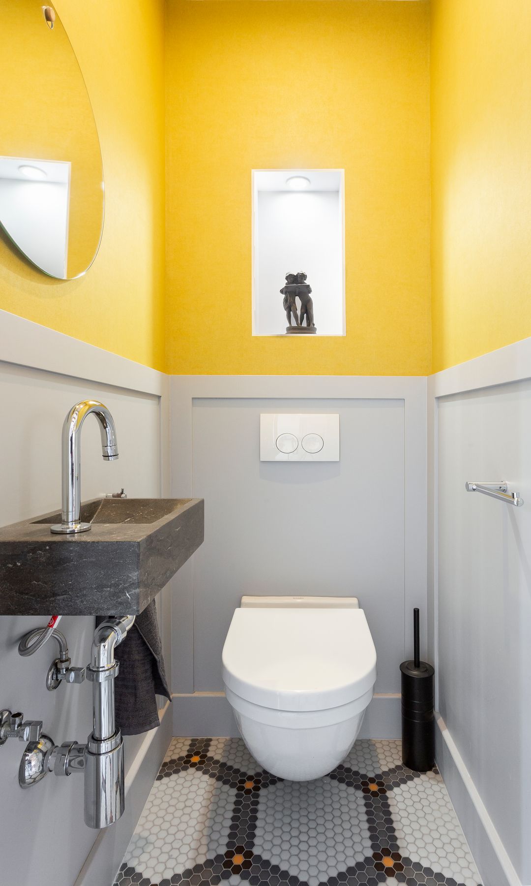 Baño pequeño pintado en amarillo y gris