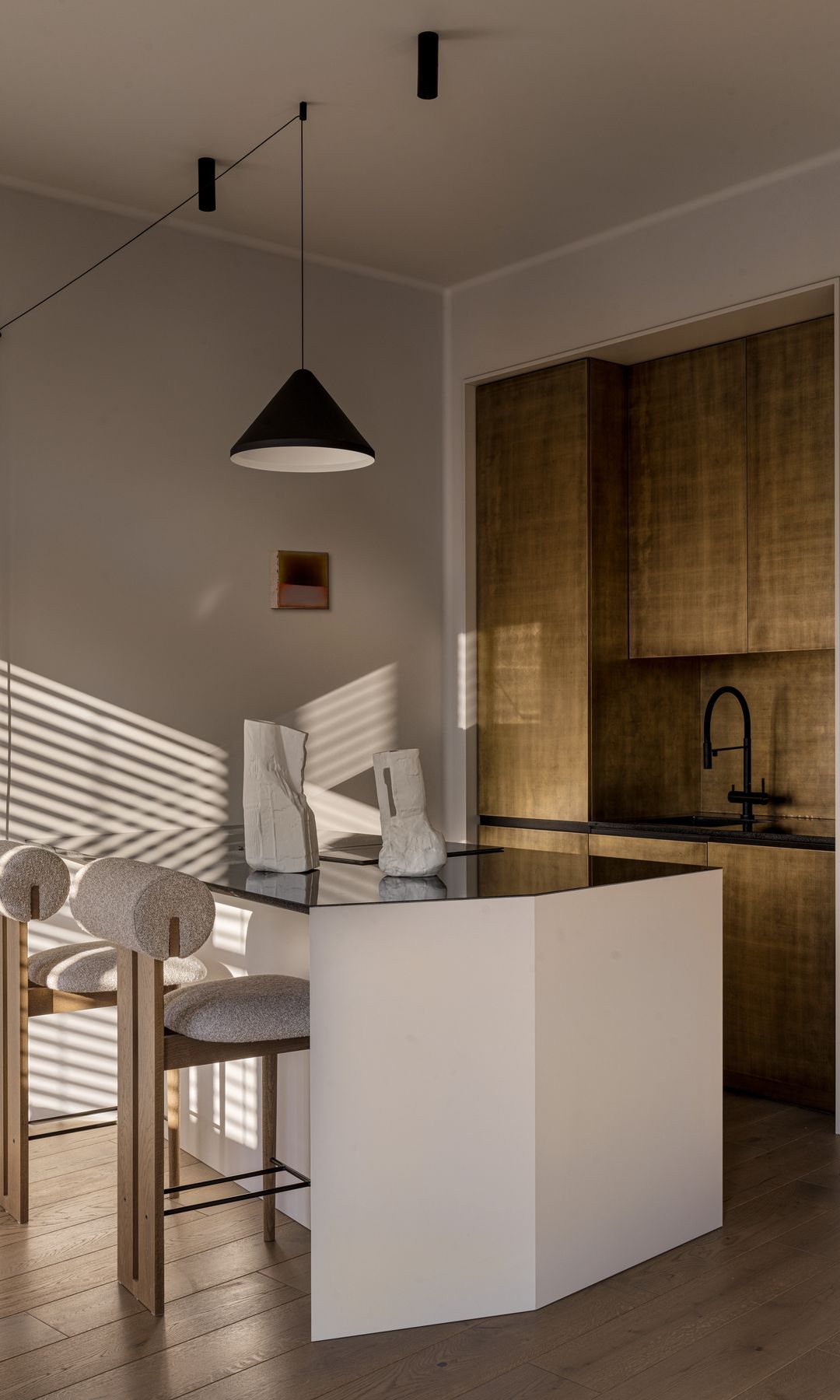 Cocina abierta moderna con isla de cocina blanca, taburetes, lámpara de techo