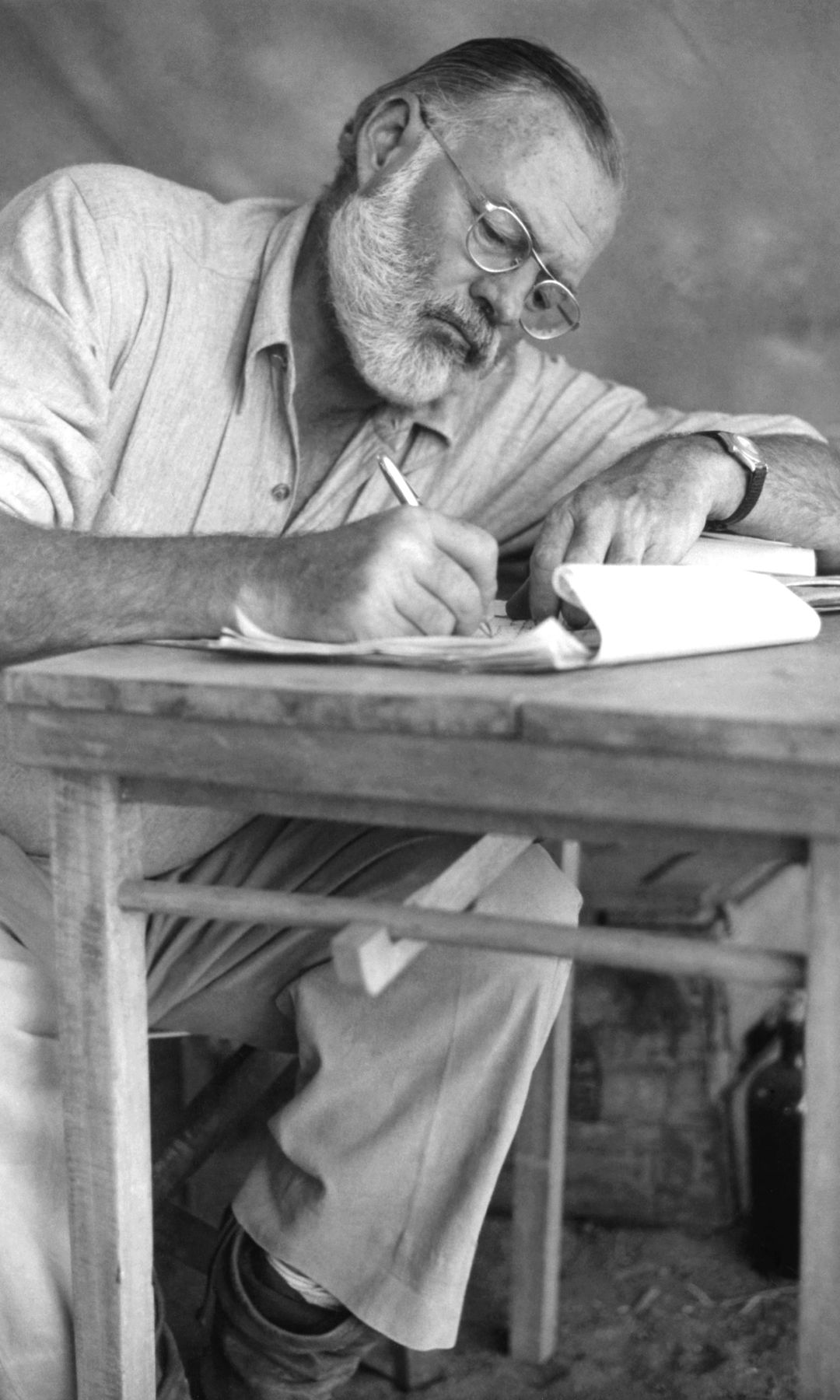 Ernest Hemingway escribiendo en una mesa
