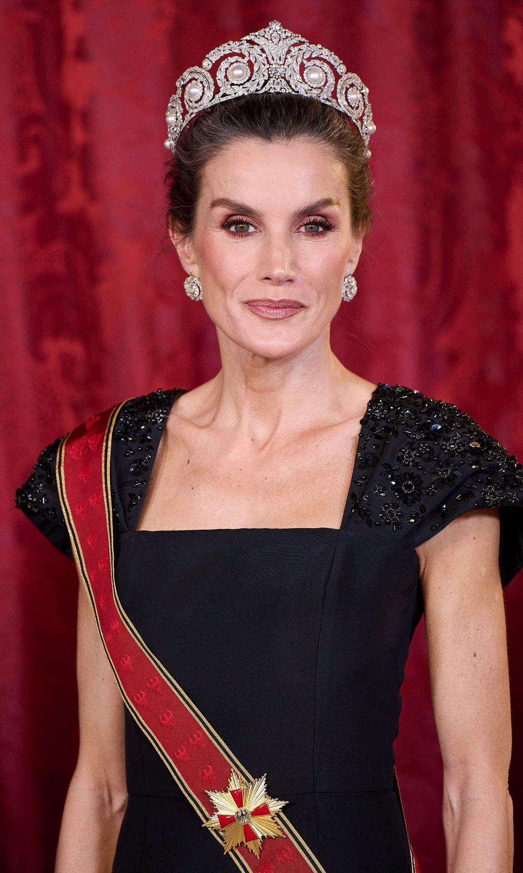 La reina con un vestido de Carolina Herrera y la tiara de Cartier