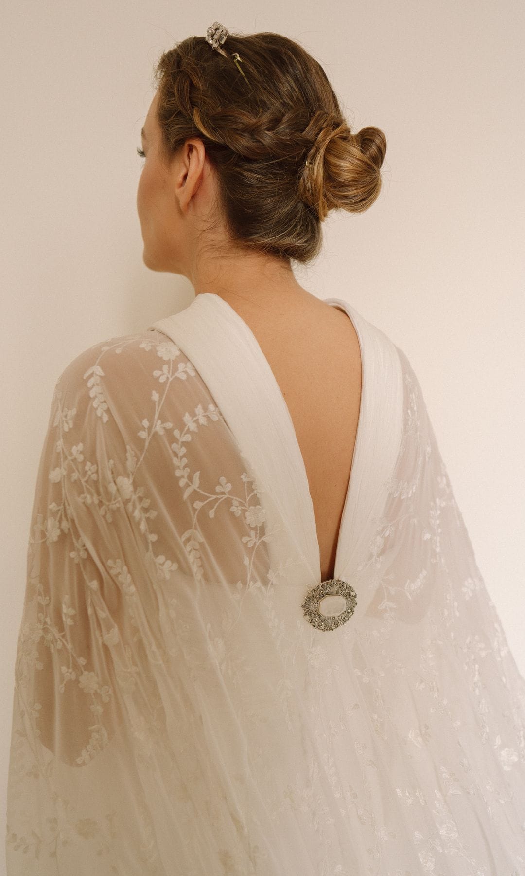 Vestido de novia convertible con capa y broche en la espalda en V de Ana Herrero de Tejada