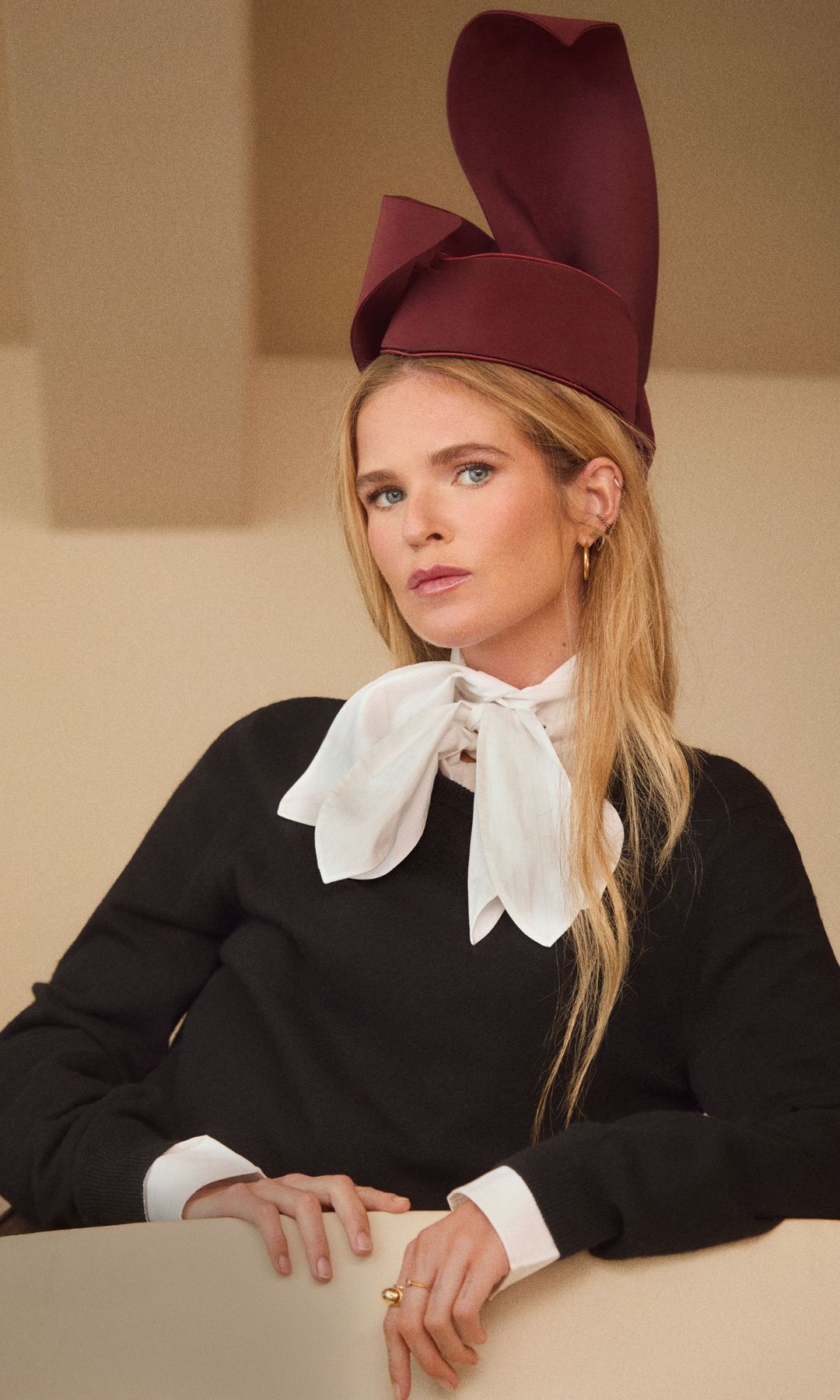 Era casi una obligación preguntárselo, así que, acometemos: “Tu madre usaba sombreros y tocados icónicos. ¿Te ves en esos territorios?”. Y… María, que tiene una carita casi dibujada para llevar sombreros (y por eso se los ponemos) nos cuenta su verdad. “No mucho… En invierno uso algún gorro de lana, pero siempre pienso que tengo la cabeza muy grande. A mi madre le encantaban. Y a mí, los de ‘cowboy’”. Maria lleva camisa, jersey, de Moschino, tocado de Vivas Carrión para Palomo Spain y anillo de Bvlgari