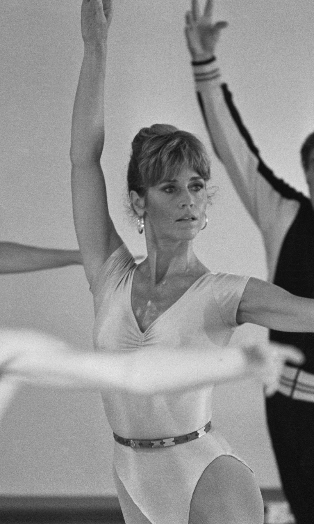 (Original Caption) 9/7/1979-Hollywood, CA: Actress Jane Fonda goes through some ballet exercise with talk show narrator Mike Douglas during taping of the "Mike Douglas Show" 9/7. Ms. Fonda is guesting on the show from her gym studio, "The Workout" which she opened recently. The show will air in early November.