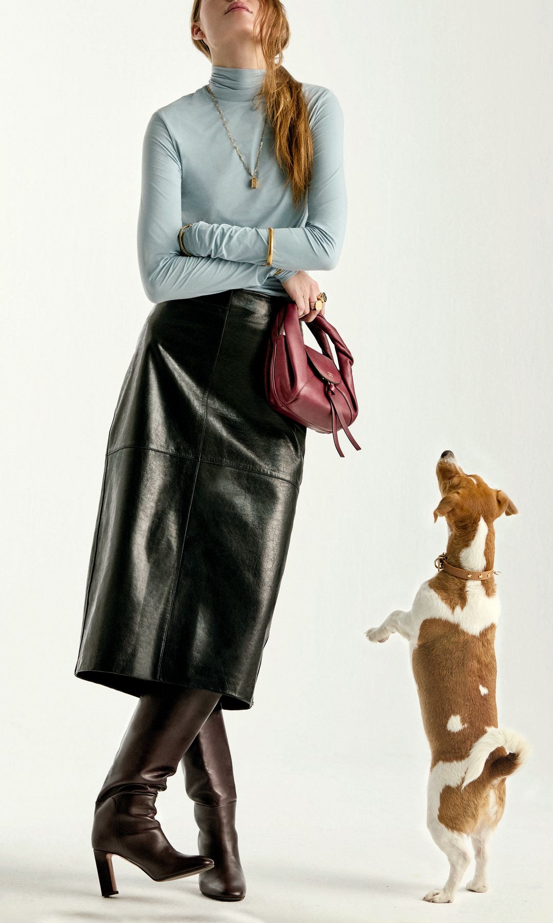 La modelo lleva jersey y falda, de Sportmax; botas, de Aquazzura; bolso, de Fendi; anillos y collar, de Louis Vuitton; pulseras de la mano izquierda, de Aristocrazy y Joyas Antiguas Sardinero, y en la mano derecha, de Tous. A su lado, la pequeña Tirma, con collar, de Branni Pets