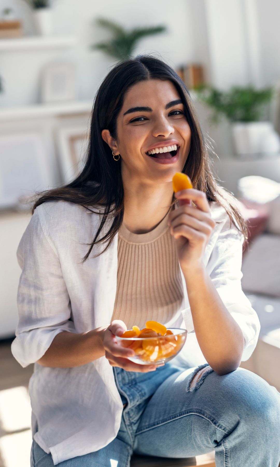 Una mujer desayunando un bol de fruta para romper el ayuno