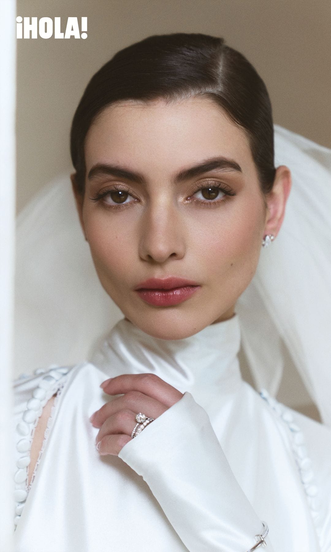 Nuestra protagonista luce aretes Victoria en platino con diamantes, un anillo de compromiso Tiffany Novo® con pavé de diamantes, acompañado por una argolla Forever, todo de Tiffany & Co.