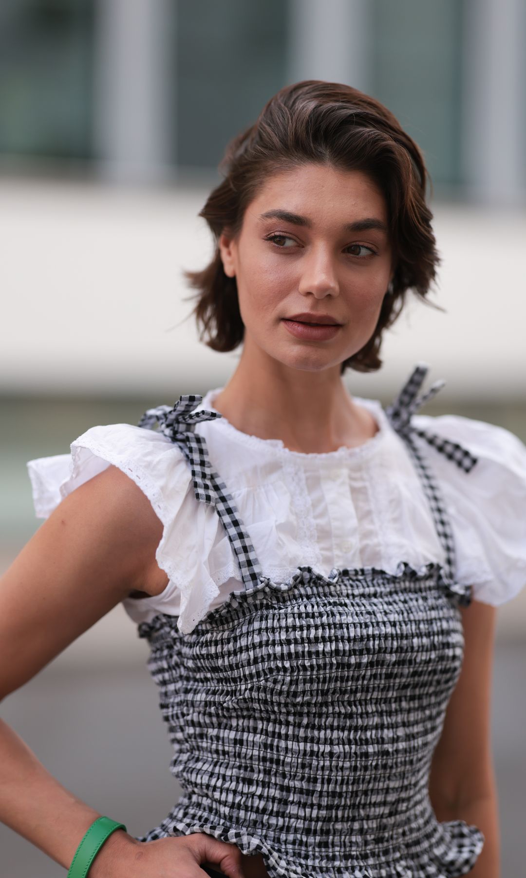 BERLIN, GERMANY - JUNE 08: Sarah Posch seen wearing a Guess top layered under a black-and-white Liu Jo blouse, paired with black H&M capri pants, black Guess slingback heels, a Chloé green lemon bag on June 08, 2026 in Berlin, Germany