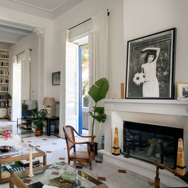 Salón con chimenea con foto en blanco y negro, librerías hasta el techo, suelo cerámico, sofá blanco, mesas de centro con sobre de cristal
