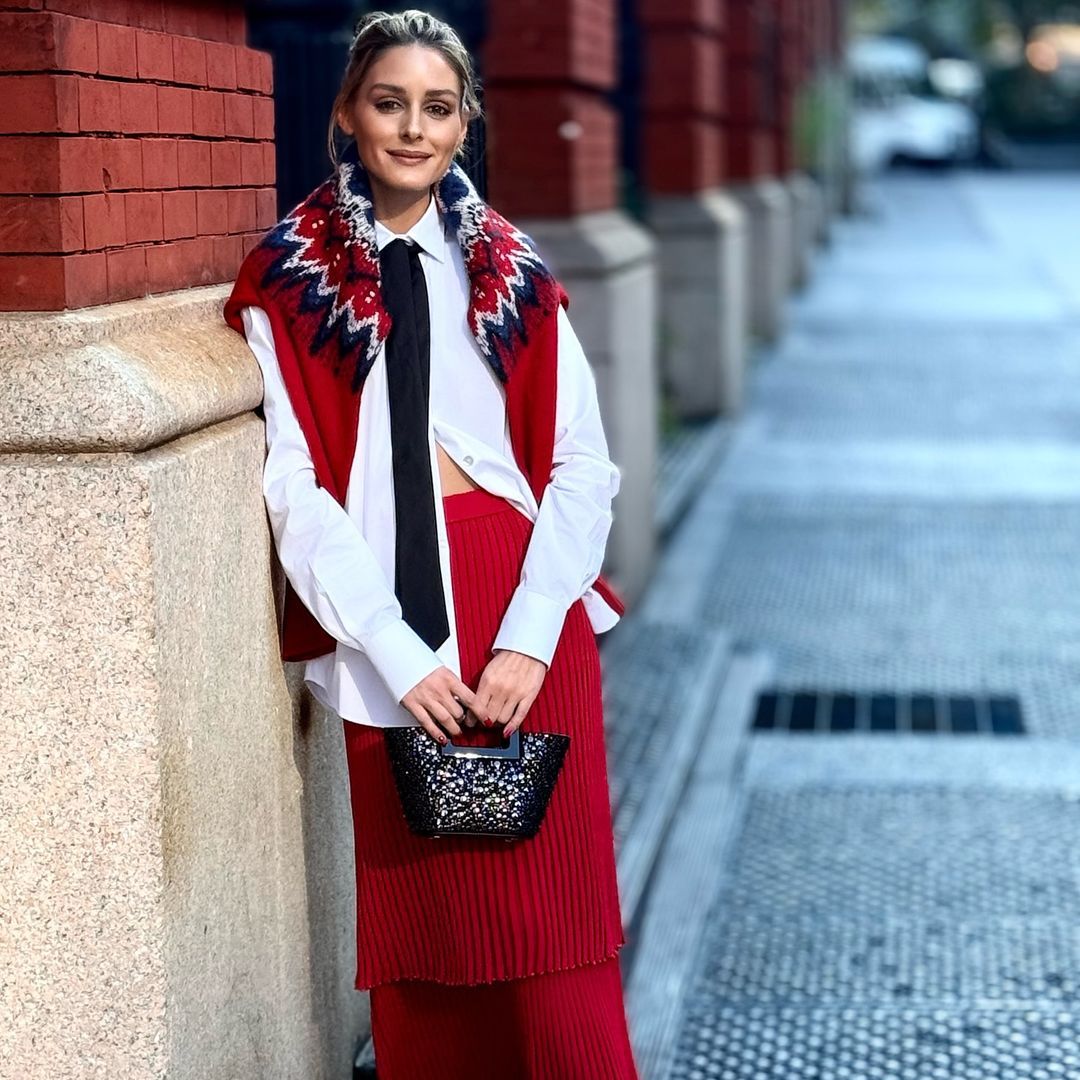 El look multitendencia de Olivia Palermo en Nueva York: corbata, jersey sobre los hombros y falda ‘midi’ de punto