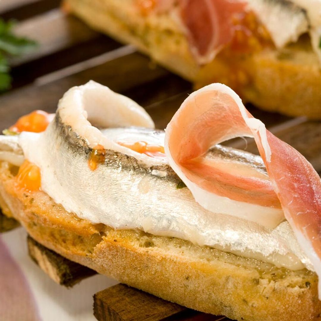 Canapé de boquerones en vinagre, jamón y tomate