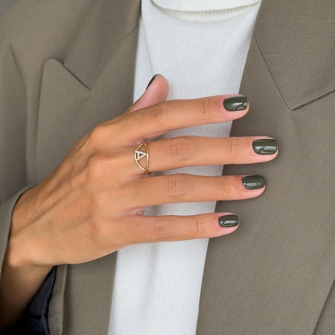 Primer plano de manicura verde oliva, jersey de cuello vuelto y chaqueta