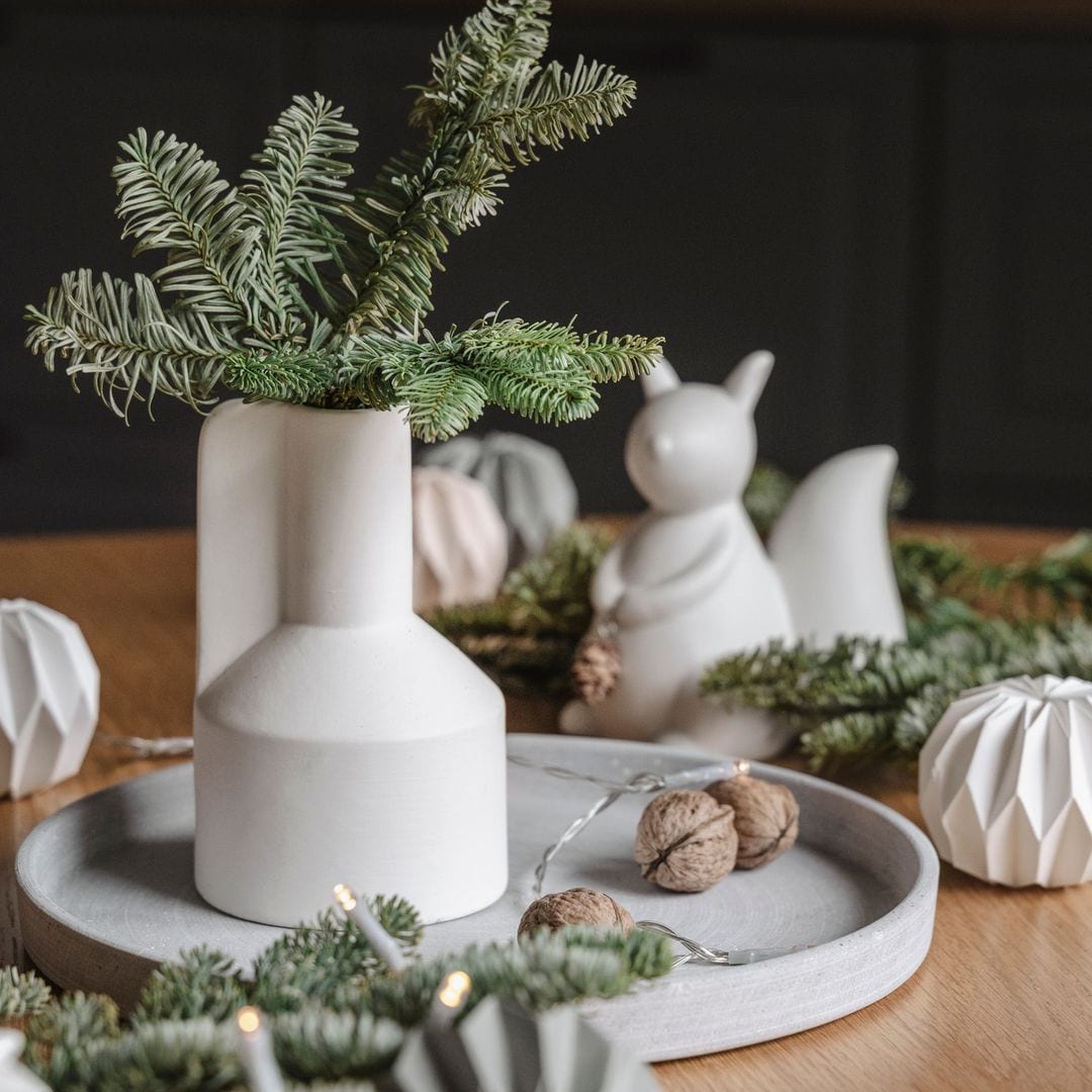 Centro de mesa de Navidad en blanco y verde ,con pino y nueces.