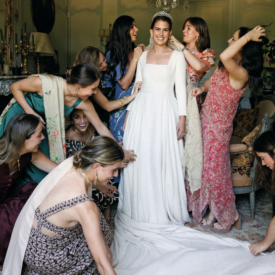 La novia preparándose antes de ir al altar, rodeada de sus amigas y mujeres de la familia