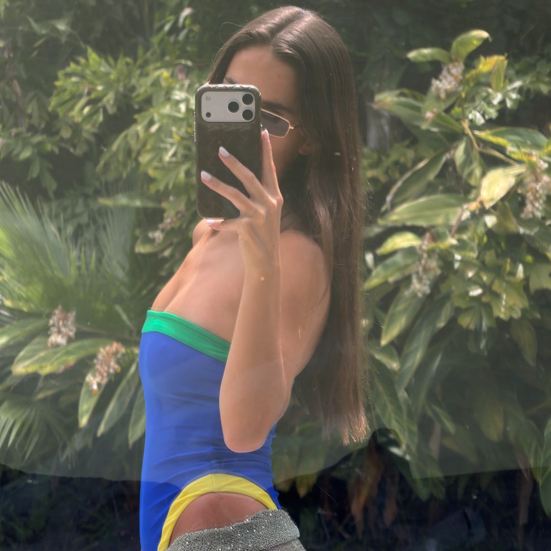 María Pombo con bañador azul palabra de honor y falda gris