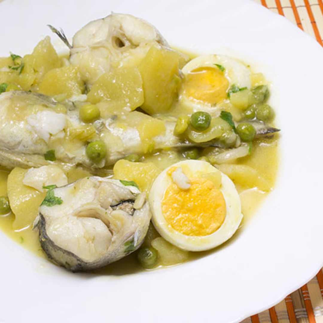 Merluza en salsa con patatas, guisantes y huevo duro
