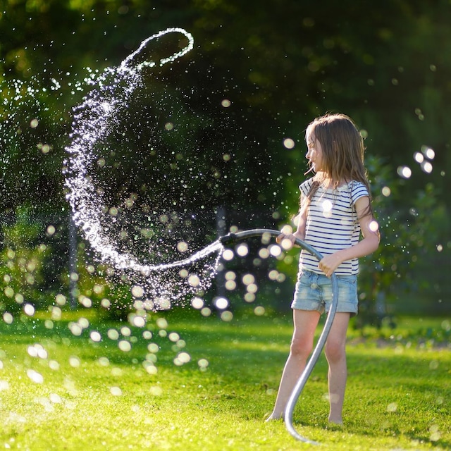 Niña jugando con una manguera