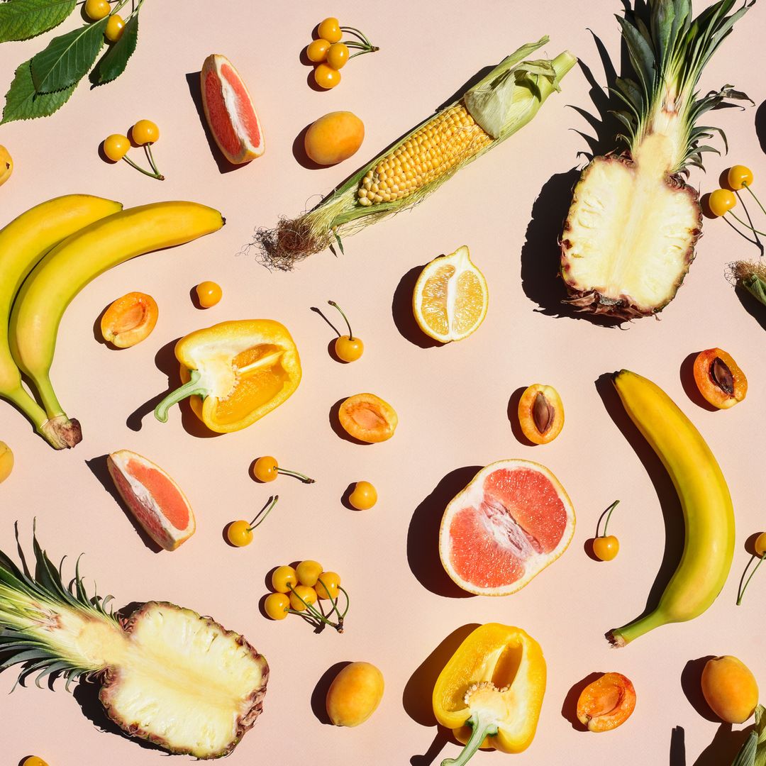 Many yellow fruits and vegetables on a yellow background. Background with food.