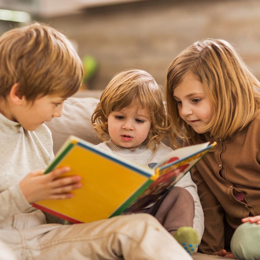 children reading picture book at home 
