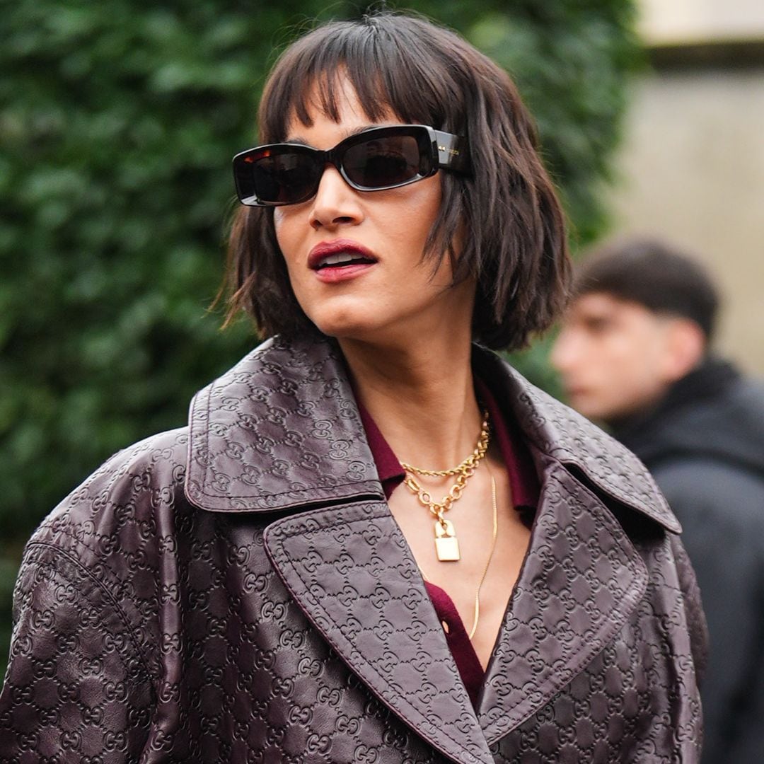MILAN, ITALY - FEBRUARY 23: Sofia Boutella wears sunglasses , a golden chain necklace , a purple / burgundy leather oversized blazer jacket with embossed monograms / logos, lipstick , outside Gucci, during the Milan Fashion Week - Womenswear Fall/Winter 2024-2025 on February 23, 2024 in Milan, Italy. (Photo by Edward Berthelot/Getty Images)