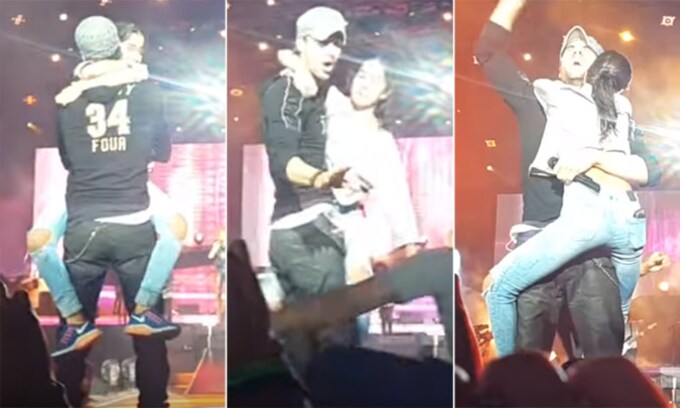 La reacción de Enrique Iglesias cuando una fan salta al escenario, le abraza... ¡y se niega a soltarle!