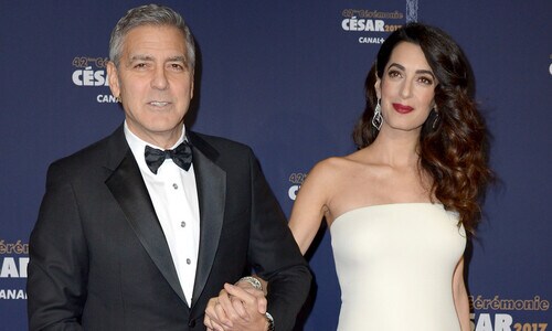 Amal Clooney's baby bump makes red carpet debut while supporting George at Cesar Awards