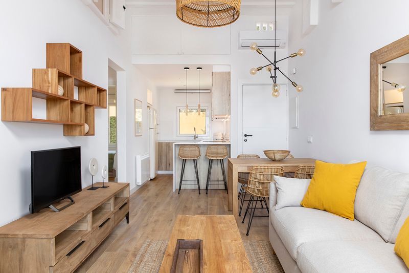Salón, comedor y cocina amueblados con las piezas principales en madera