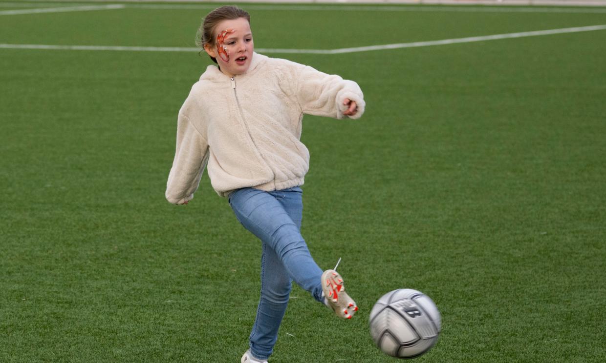 Mia Tindall plays football with her dad Mike Tindall