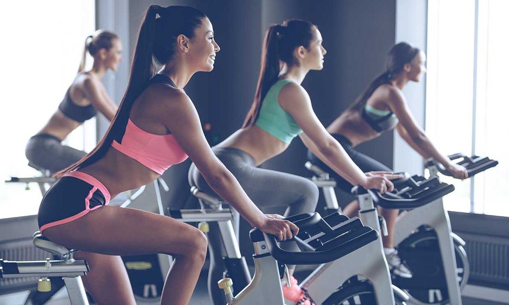 Spinning girl. Сайкл тренировка до и после. Beautiful woman exercising at Home Bicycle.