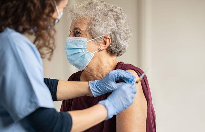 Mujer anciana vacunada COVID