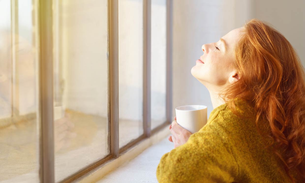 mujer relajada mirando por la ventana