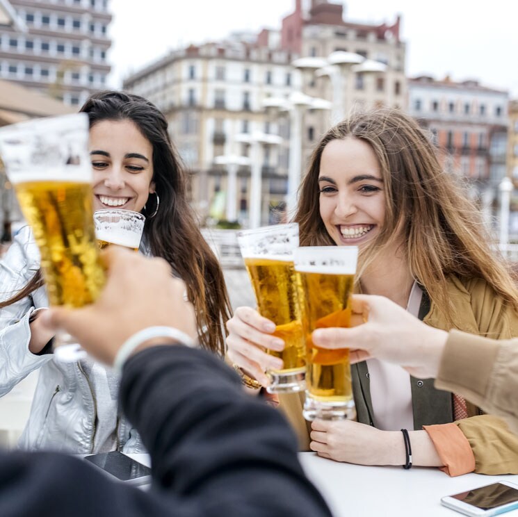 Amigos tomando una cerveza en la terraza de un bar