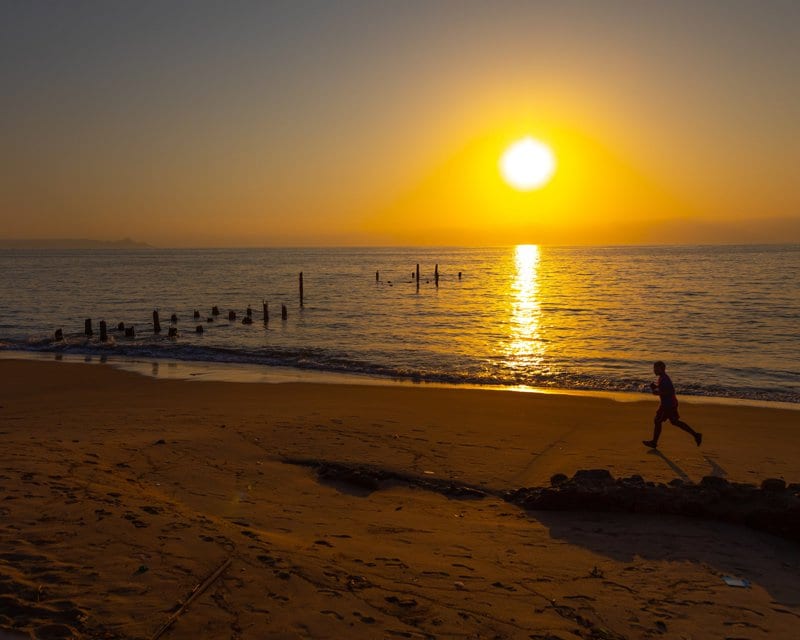 Man running on the beach at sunset, Benguela Province, Benguela, Angola