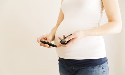 Mujer embarazada controlándose la glucosa