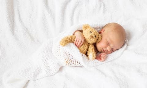 Newborn baby with teddy bear